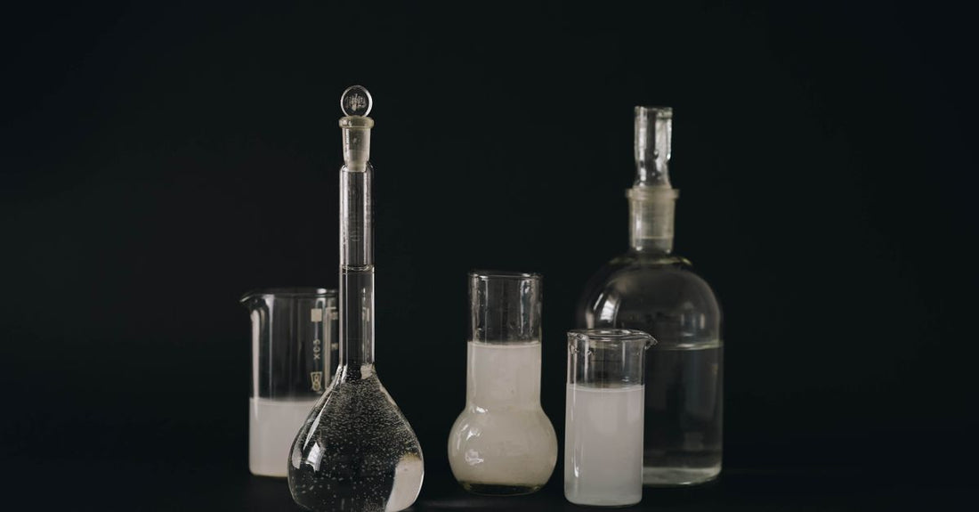 A selection of the best conditioners 2026 placed on a clean white surface with data charts visible in the background, representing a price-quality analysis.