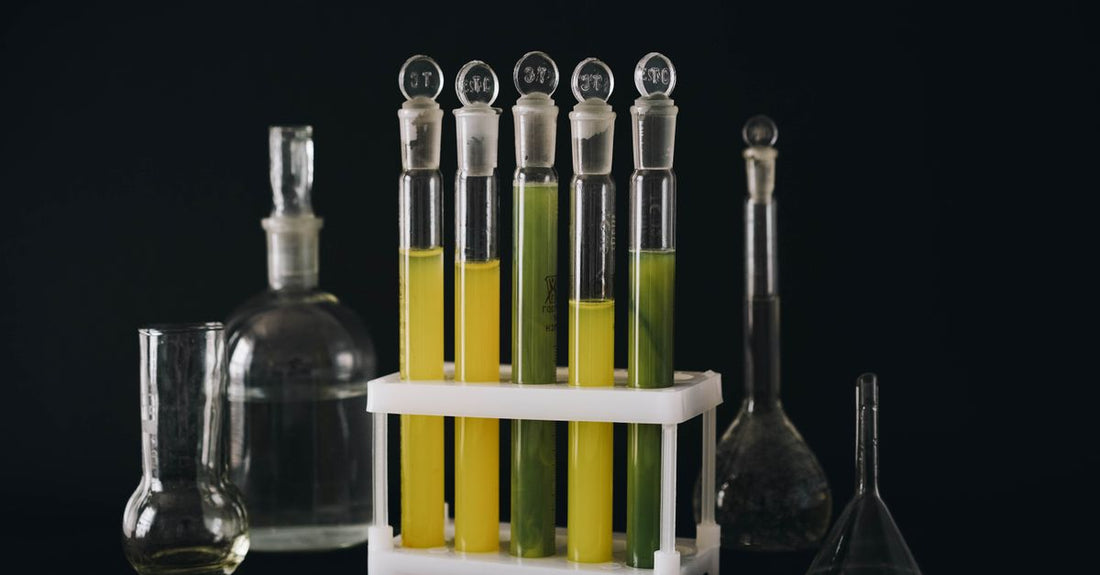 A conditioners buying guide hero image showing a sleek conditioner bottle on a minimalist laboratory shelf with scientific glassware.