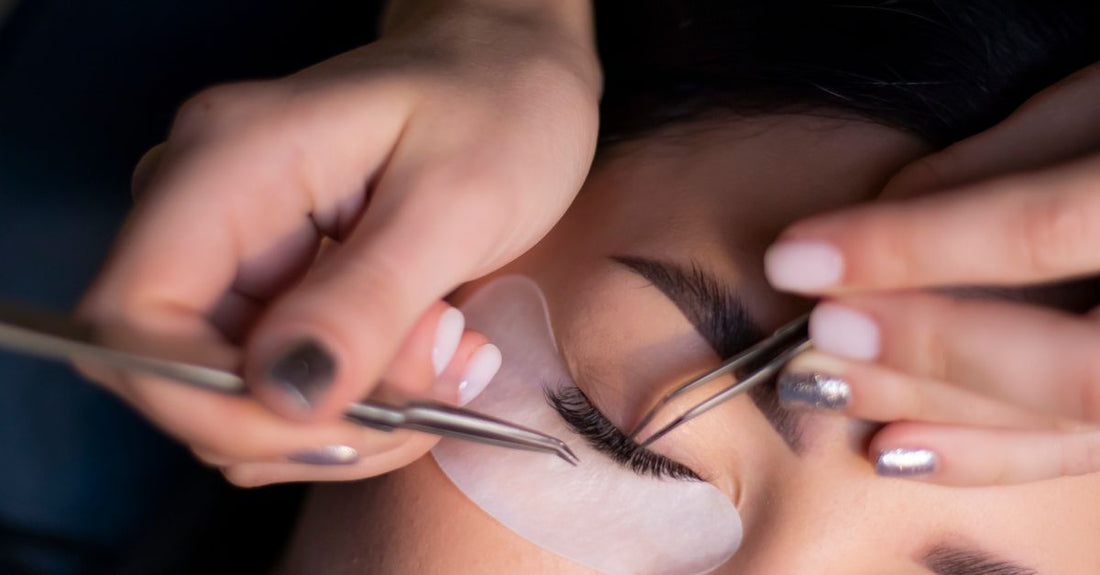 A bottle of latex-free lash glue on a white background, demonstrating how to choose adhesives UK for sensitive eyes.