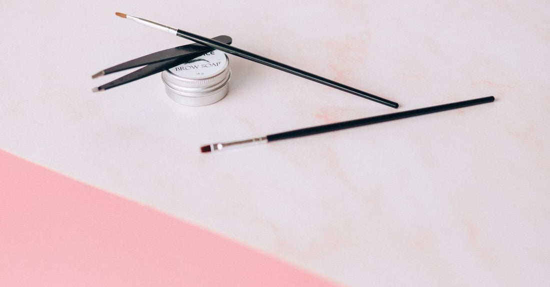 Eyebrow stamp stencil kit and brow pencils on a white background, illustrating an eyebrow color buying guide UK