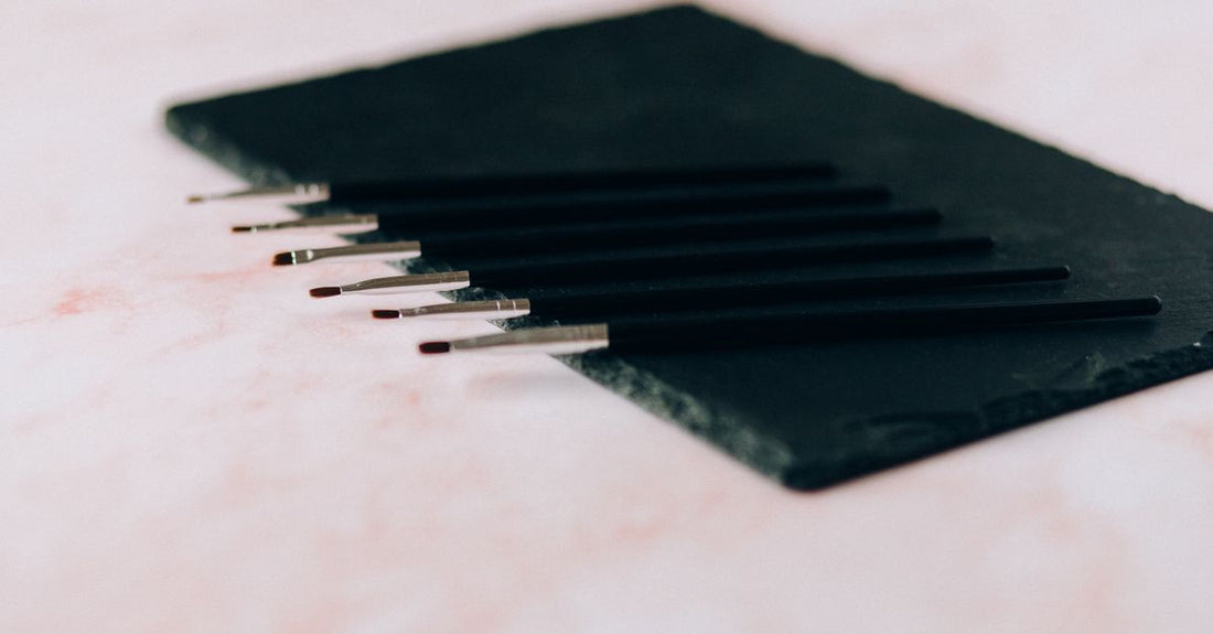 A collection of professional makeup brush sets displayed in a flatlay arrangement, illustrating a brush sets buying guide for UK shoppers.