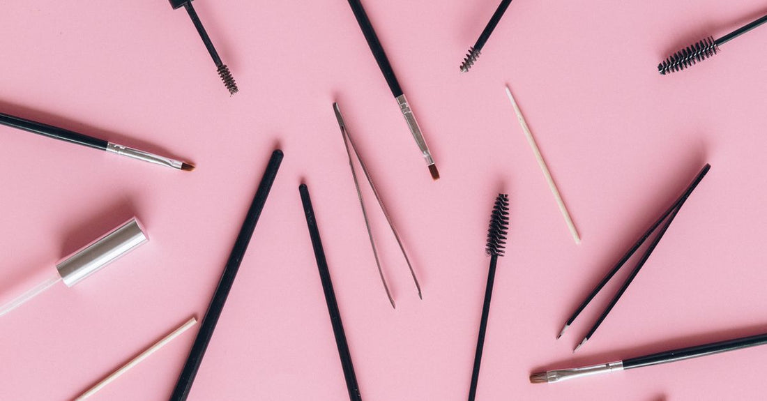 A flatlay of hair styling tools including clips and a styling treatment bottle, illustrating a styling treatments buying guide UK.