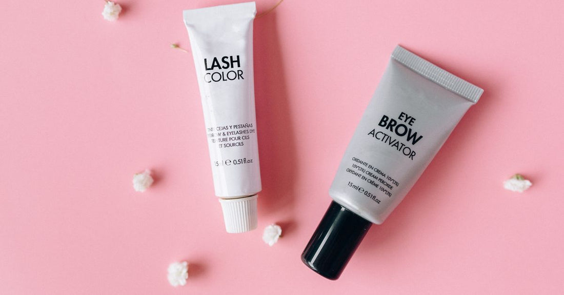 How to use eyelash primer for volume: a white eyelash primer tube on a clean makeup surface