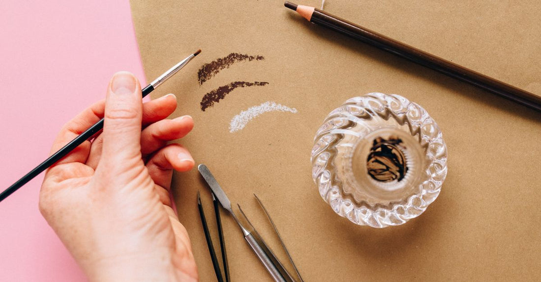 A selection of the best eyebrow pencil for natural look on a clean beauty flatlay background, showing pencil tips and swatches.