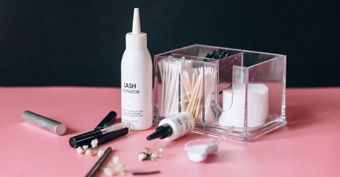 A selection of the best beauty adhesives UK 2026 laid on a clean white surface, including wig glue, nail tabs, and lash bonder.