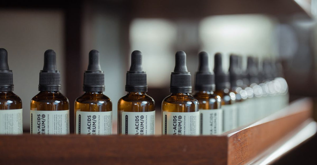 A row of hair regrowth serum bottles on a bathroom shelf, illustrating the best hair regrowth treatments UK 2026.