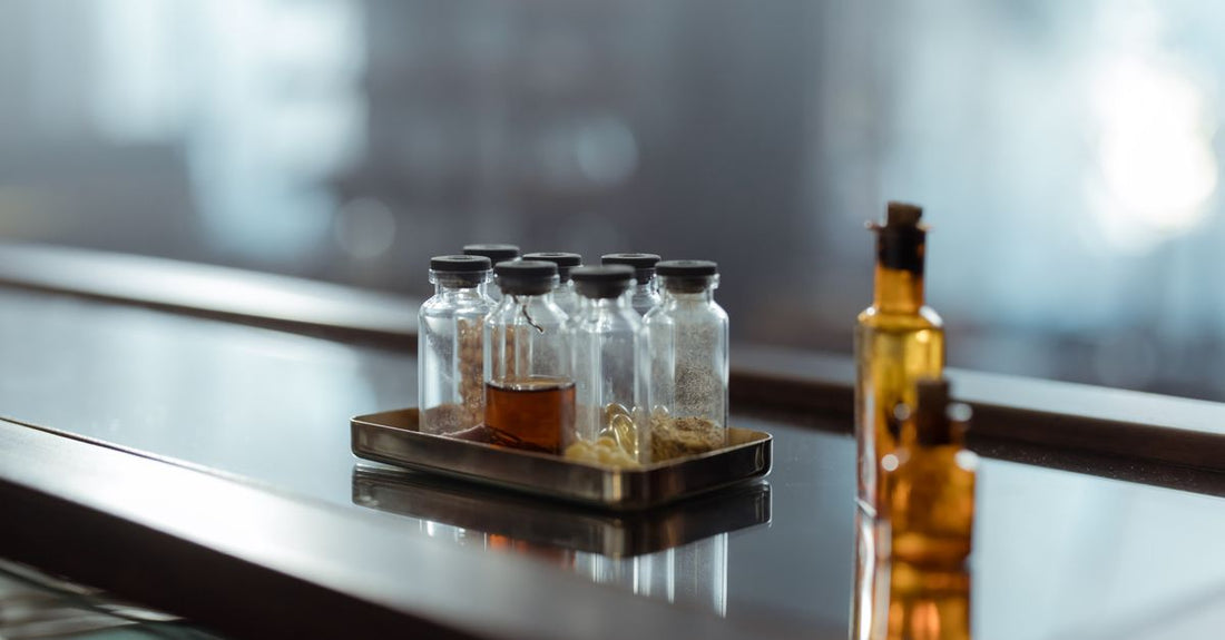 A row of conditioner bottles on a laboratory shelf, illustrating how to choose conditioners based on science and ingredients.