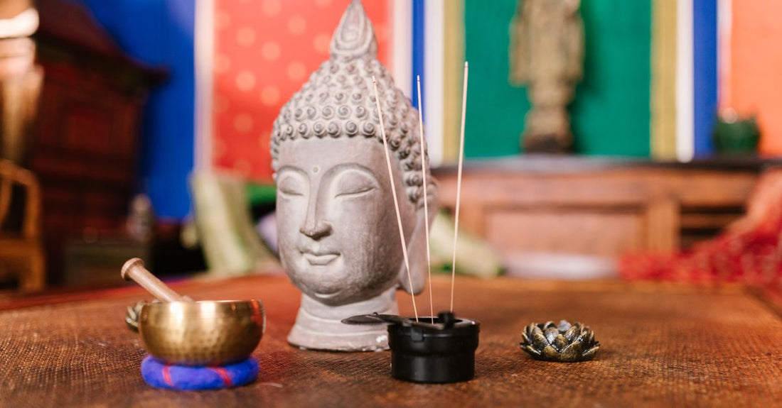 A selection of incense sticks burning in a ceramic bowl, illustrating an incense buying guide UK.