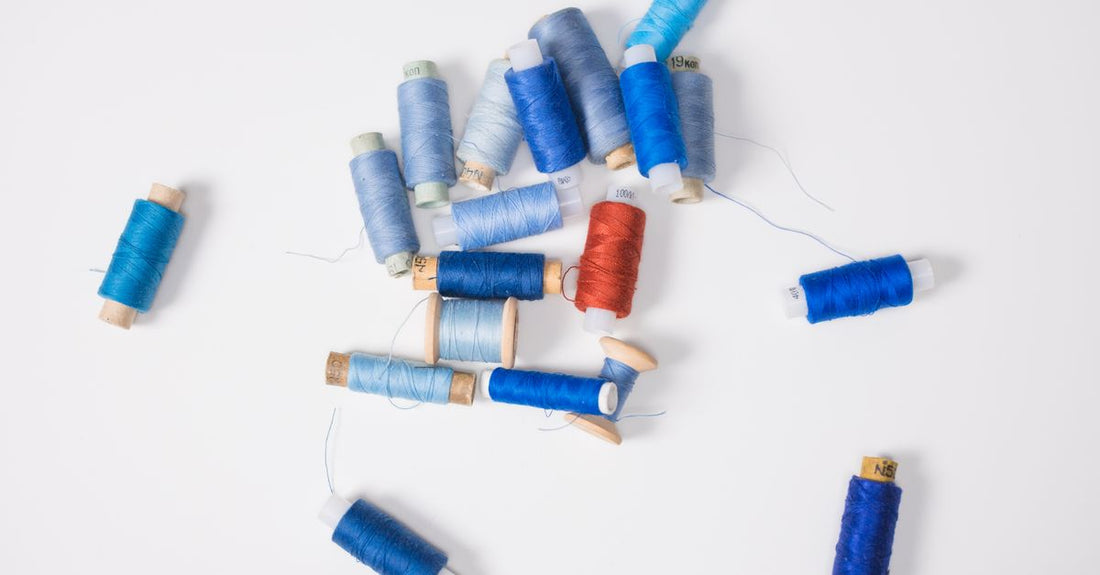 A flatlay of various hair elastics and ties including spiral, satin, and cotton styles, illustrating how to choose elastics and ties for different hair types.