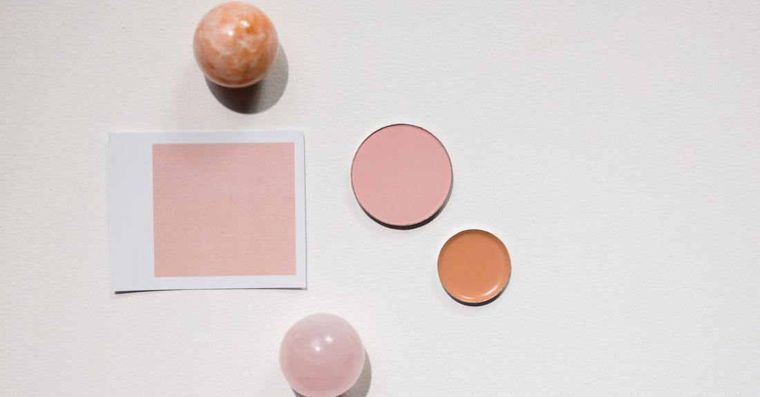 A peach color corrector palette open on a white surface, showing six cream shades, ideal for how to use color corrector for dark spots.