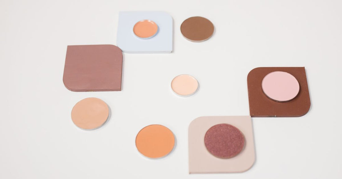 A flatlay of a neutral eyeshadow palette with brushes, illustrating how to apply eyeshadow for beginners