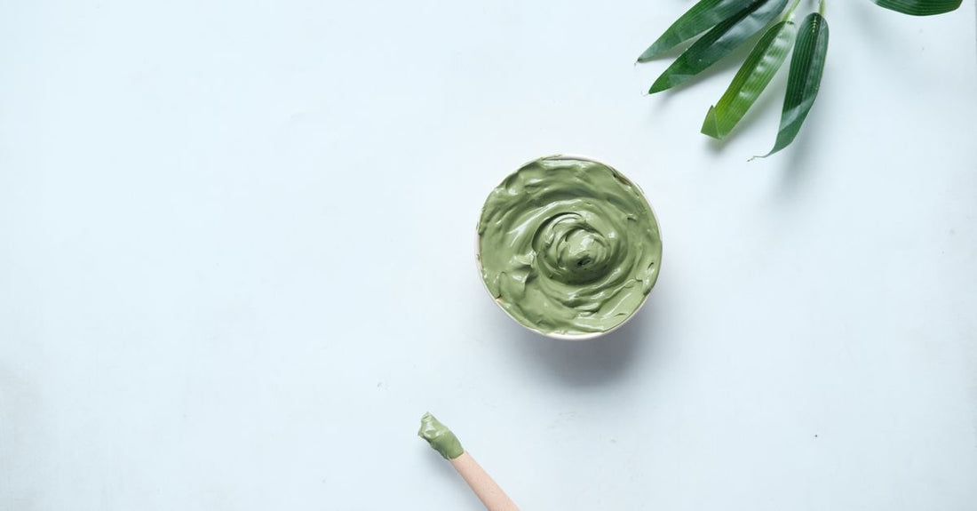 A jar of clay face mask on a light background, illustrating how to use a clay mask for oily skin correctly.