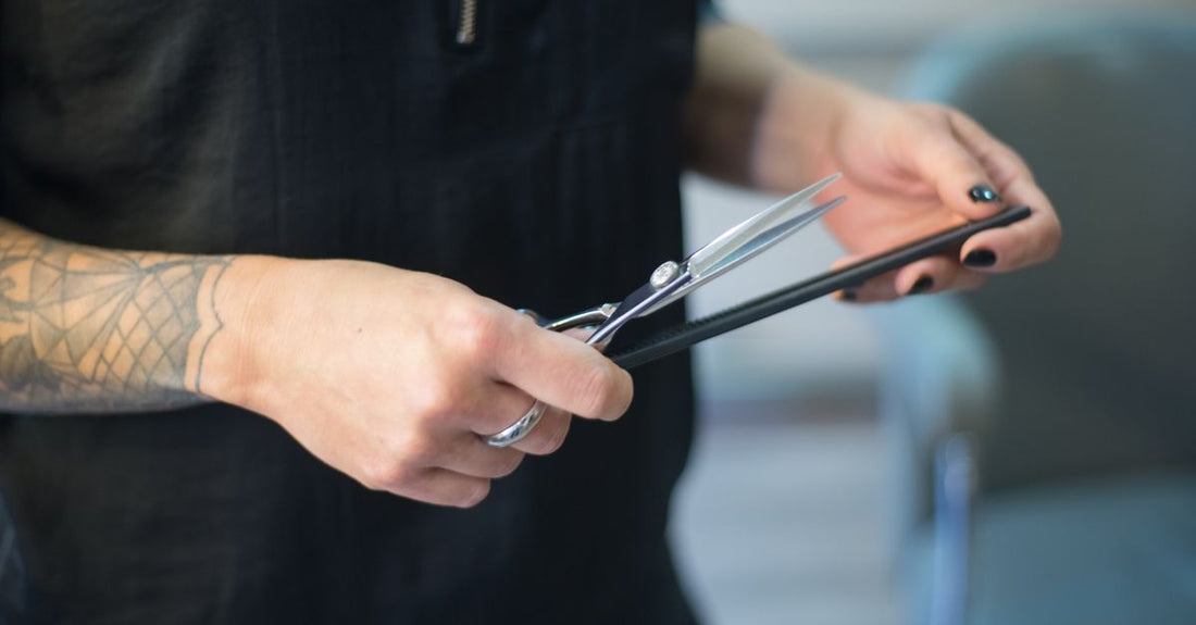 A selection of best cuticle pushers 2026 including ceramic, stainless steel, and glass tools arranged on a marble surface.