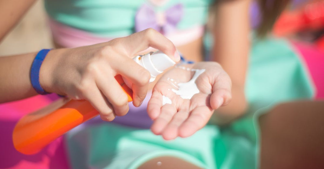 A sunscreen spray bottle on a white background, demonstrating how to reapply sunscreen over makeup