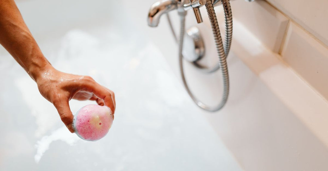 Best bath bombs 2026 fizzing in a bathtub with colourful swirls and essential oil bubbles, representing a relaxing UK evening soak.