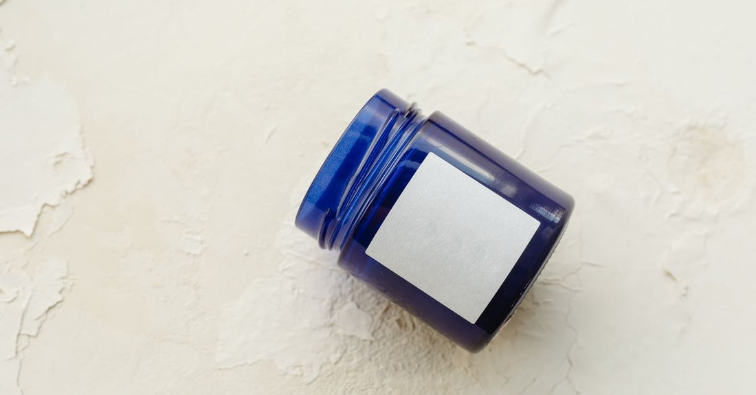 A selection of face moisturiser jars and tubes arranged neatly on a white surface, illustrating how to choose face moisturizers UK.