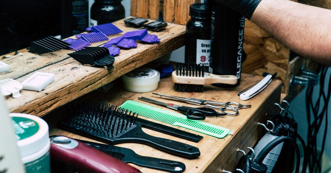 Flatlay of hair styling products including cream, wax, comb, and brush on a neutral background for a styling products buying guide UK.