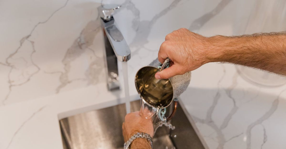 A stylish hand wash bottle on a marble bathroom counter, representing the best hand wash 2026 for long-term skin health.