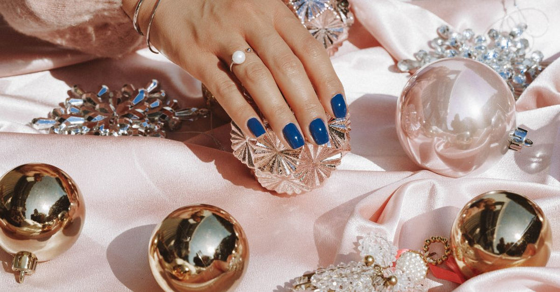 Flatlay of assorted nail decoration kits with rhinestones, charms, and magnets on a white background, illustrating a decoration kits buying guide