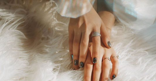 A flatlay of essential nail art accessories for beginners, including dotting tools, stampers, and brushes, perfect for a nail art accessories buying guide.