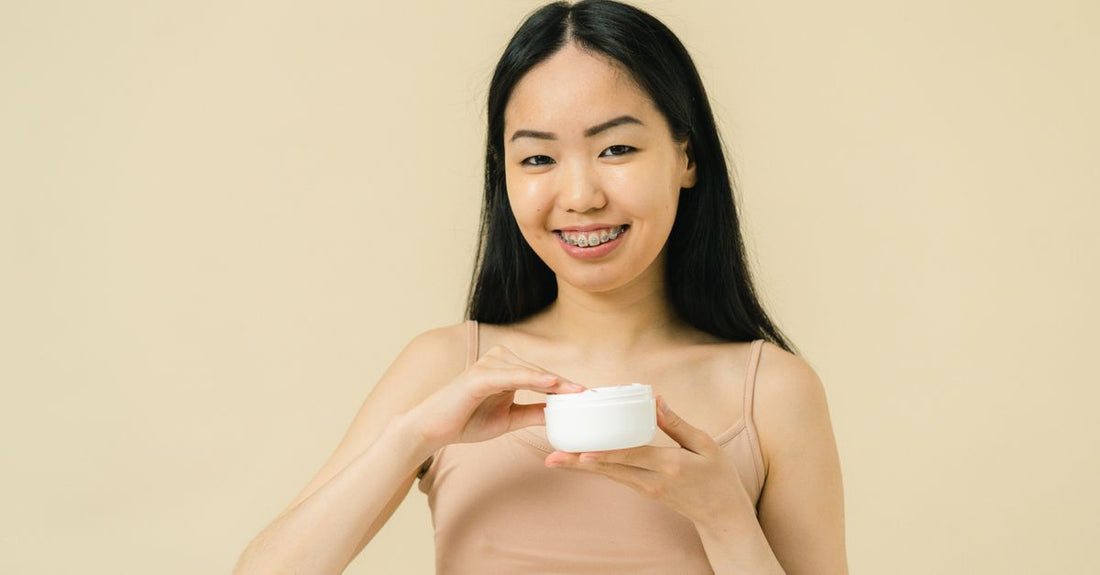 A curated flatlay of skincare aftercare products including a soothing balm, cleansing mist, and green soap kit, illustrating how to choose aftercare products for long-term skin health.