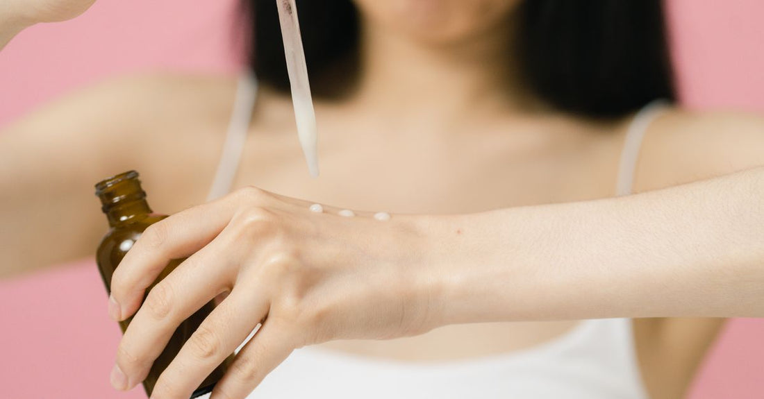 A selection of face skincare products including serums and moisturisers on a white surface, illustrating a face buying guide.