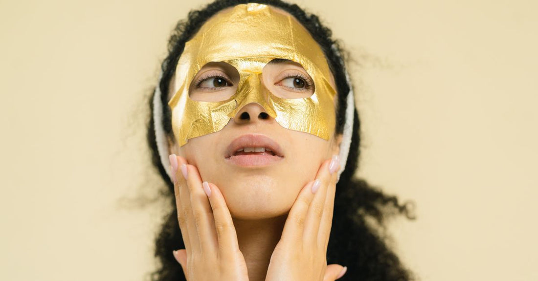 Selection of face masks including clay, sheet, and cream formulations on a marble surface, representing how to choose masks for different skin types.
