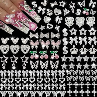 KACHIMOO 106 Pcs Nail Charms and Gems - Silver Nail Rhinestones 3D Butterfly, Bow, Star, Cherry, Cross, Dollar, Heart Shapes for Acrylic Nails (19 Styles)
