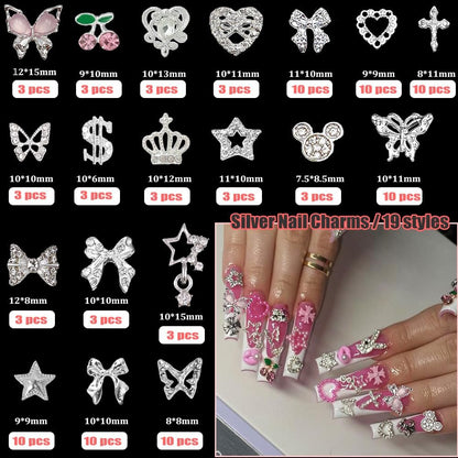 KACHIMOO 106 Pcs Nail Charms and Gems - Silver Nail Rhinestones 3D Butterfly, Bow, Star, Cherry, Cross, Dollar, Heart Shapes for Acrylic Nails (19 Styles)