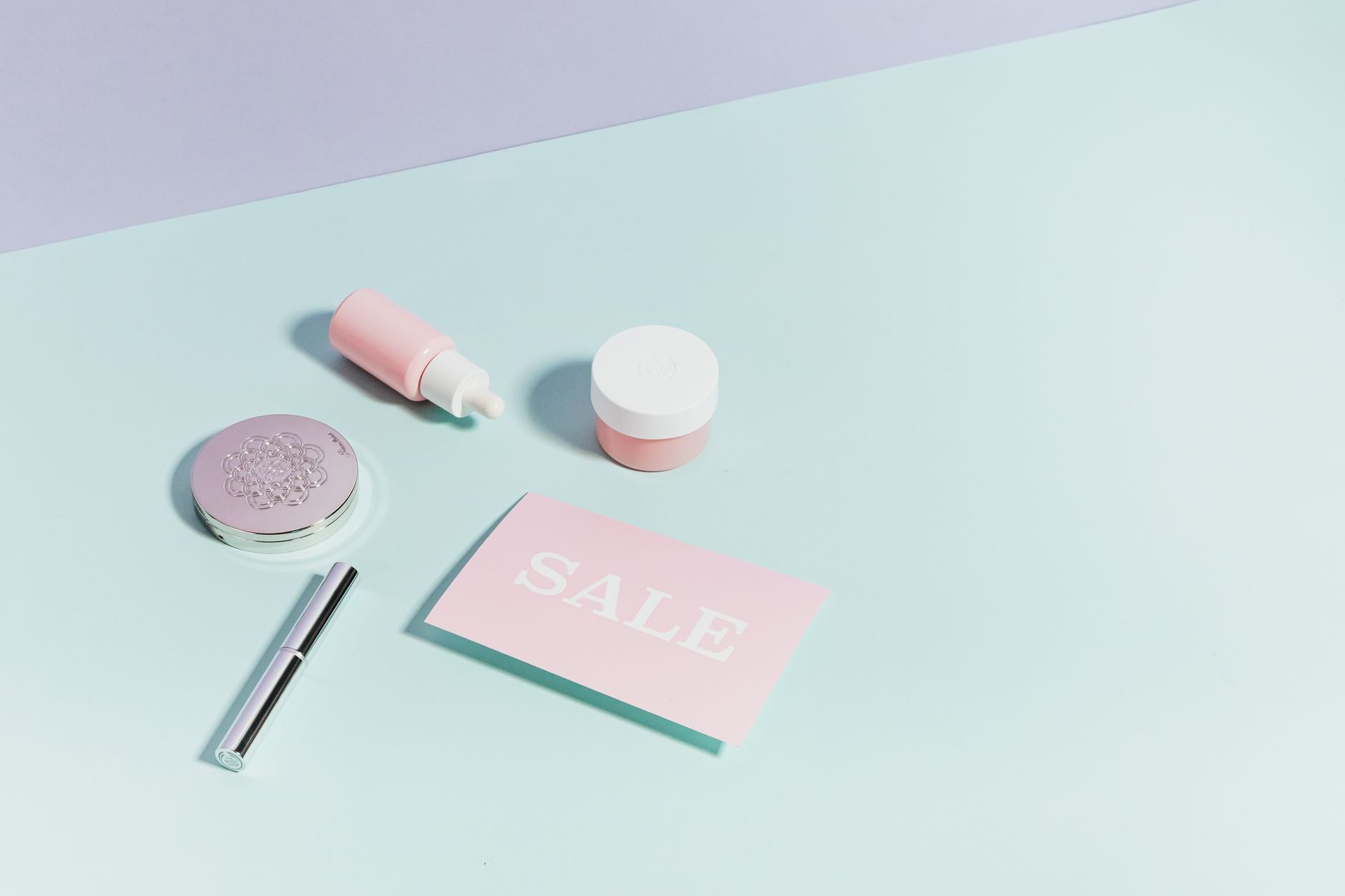 Skincare serum and treatment bottles arranged on a warm surface