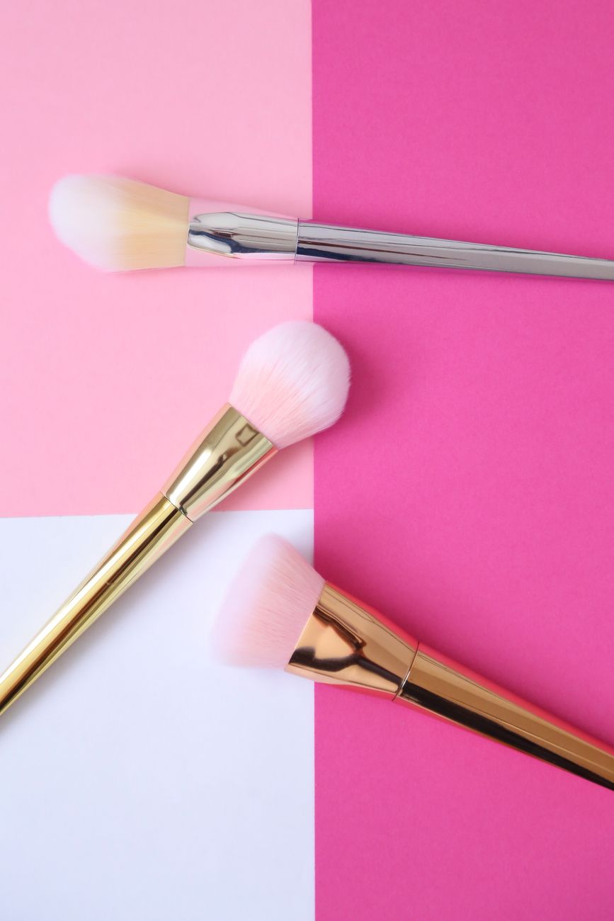 Cosmetics and fragrance products arranged in a flat lay
